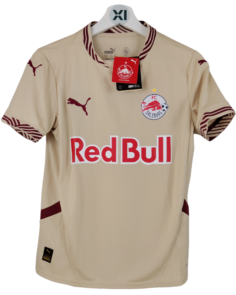 Beige FC Red Bull Salzburg soccer jersey on a hanger, showing sponsor logo across the chest and club crest on the left chest.